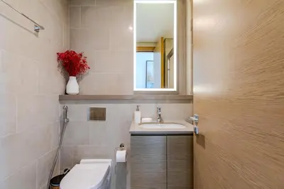 a bathroom with a sink and a mirror at Sobha waves I Cozy 1BDR I Burj Khalifa View in Dubai