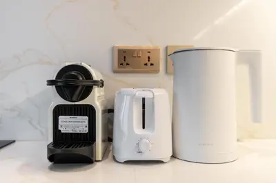 a kitchen counter with a toaster and a blender at Upgraded Designer-crafted Studio in JVC with Massive Terrace in Dubai