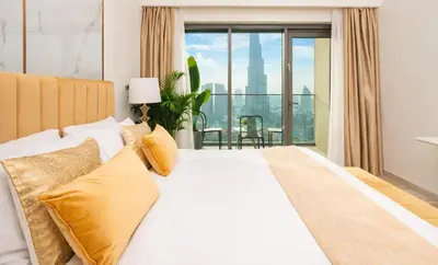 a bedroom with a large bed with a view of the city at Elite Royal Apartment - Sky Series - Full Panoramic Burj Khalifa & Fountain View - Icon in Dubai