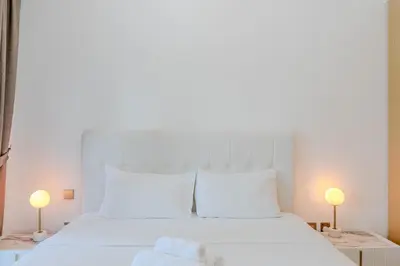 a white bed with white pillows and two lamps at New I Modern I 1BDR I 17 Icon Bay Tower 2 in Dubai