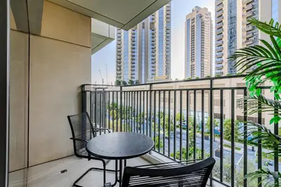 a balcony with a table and chairs and buildings at New I Modern I 1BDR I 17 Icon Bay Tower 2 in Dubai