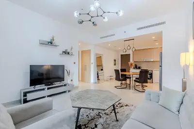 a living room with a couch and a tv and a table at New I Modern I 1BDR I 17 Icon Bay Tower 2 in Dubai