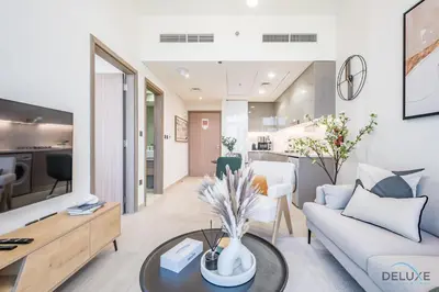 a living room with a couch and a table at Delightful 1BR Apartment in Azizi Riviera 22, Al Merkadh by Deluxe Holiday Homes in Dubai