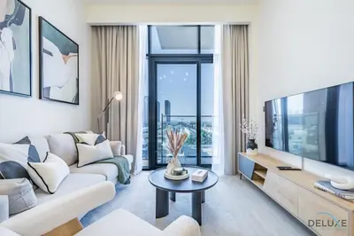 a living room with a couch and a tv at Delightful 1BR Apartment in Azizi Riviera 22, Al Merkadh by Deluxe Holiday Homes in Dubai
