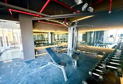 a gym with a lot of chairs and machines at Locations I Uni Estate Supreme Residence I Luxury 1BR I Near Miracle Garden I Pool, Gym & Parking in Dubai