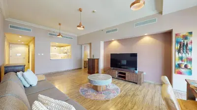 a living room with a couch and a flat screen tv at Golden Mile 1 - Contemporary One Bedroom in Dubai
