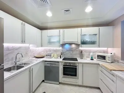 a kitchen with a sink and a stove top oven at Golden Mile 1 - Contemporary One Bedroom in Dubai