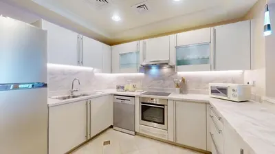a kitchen with white cabinets and a sink at Golden Mile 1 - Contemporary One Bedroom in Dubai