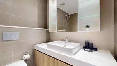 a bathroom with a white sink and a mirror at Liv Residences - Spacious Two Bedroom in Dubai