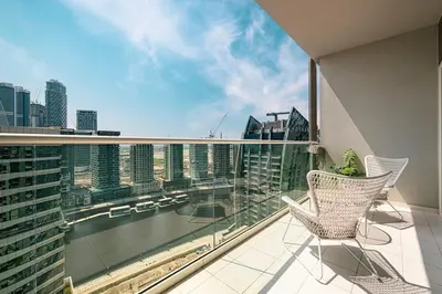 a balcony with two chairs and a view of a city at LUXE | 1BR | Close to Burj Khalifa & Dubai Mall in Dubai