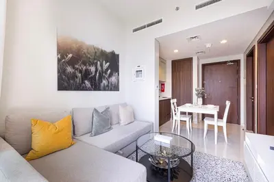 a living room with a couch and a table at LUXE | 1BR | Close to Burj Khalifa & Dubai Mall in Dubai