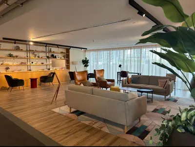 a living room with a couch and chairs and a table at Socio Tower1 - Dubai Hills Modern Urban Retreat in the City by Serenity Living Holiday Homes in Dubai