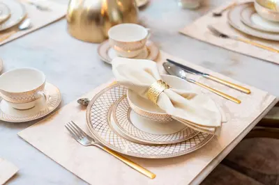a table with plates and forks and napkins at Elite Royal Apartment - Sky Series - Full Burj Khalifa & Fountain View - Noble in Dubai
