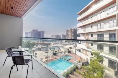 an apartment balcony with a view of a pool at Manzil - 1BR Apartment in Marquis Signature with City Views in Dubai