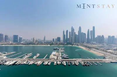 an aerial view of a marina in front of a city at Marina Vista 2, Emaar Beachfront - Mint Stay in Dubai