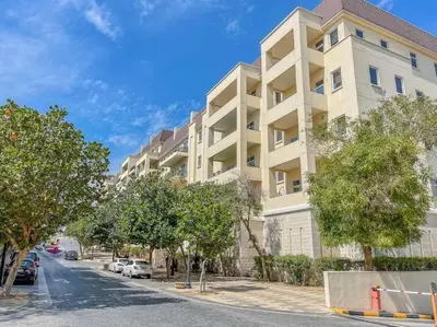 an apartment building on the side of a street at Peaceful flat in Motor City in Dubai