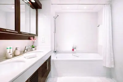 a white bathroom with a tub and a sink at Elite Royal Apartment - Sky Series - Ful Burj Khalifa & Fountain View - Prodigy in Dubai