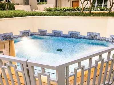 a swimming pool with blue tiles on a fence at Elite Royal Apartment - Sky Series - Ful Burj Khalifa & Fountain View - Prodigy in Dubai