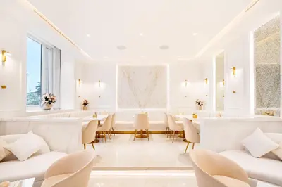 a white salon with white chairs and tables at Elite Royal Apartment - Sky Series - Ful Burj Khalifa & Fountain View - Prodigy in Dubai