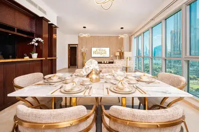 a dining room with a large table and chairs at Elite Royal Apartment - Sky Series - Ful Burj Khalifa & Fountain View - Prodigy in Dubai
