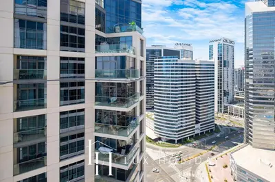 an aerial view of a tall building in a city at LUX The Executive Burj Khalifa View Suite in Dubai