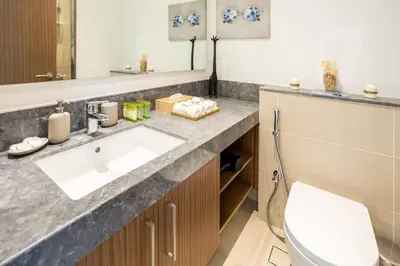 a bathroom with a sink and a toilet at Waves - 52 42 Emaar, Tower 1 in Dubai