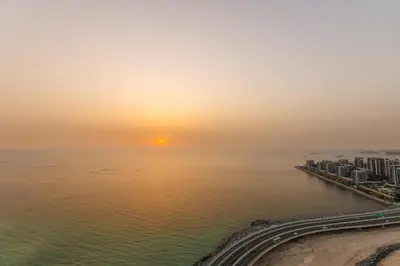 an aerial view of the ocean at sunset at Waves - 52 42 Emaar, Tower 1 in Dubai