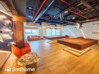 a large living room with a couch and a table at 2ndHome - Me Do Re , Cluster L, JLT in Dubai