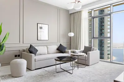 a living room with a couch and a table at Silkhaus Sea View Stunning 1BDR with Private Beach in Dubai