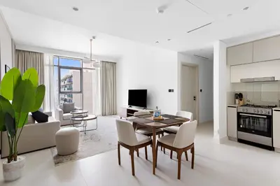 a kitchen and living room with a table and chairs at Silkhaus Sea View Stunning 1BDR with Private Beach in Dubai