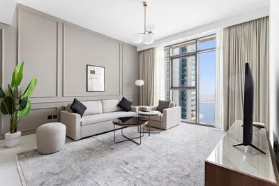 a living room with a couch and a table at Silkhaus Sea View Stunning 1BDR with Private Beach in Dubai