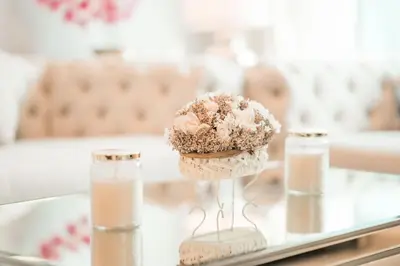 a cupcake on a glass table with two bottles of milk at Elite Royal Apartment - Full Burj Khalifa & Fountain View - Luxurious - Viceroy in Dubai