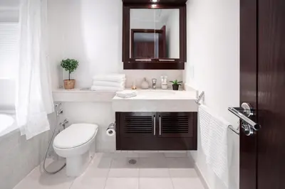 a bathroom with a toilet and a sink and a mirror at Elite Royal Apartment - Full Burj Khalifa & Fountain View - Luxurious - Viceroy in Dubai