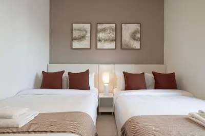 two beds sitting next to each other in a room at Burj Crown - Downtown Elegance Opera Boulevard View by Dubai Mall in Dubai