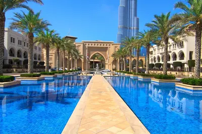 a pool in the middle of a building with palm trees at Burj Crown - Downtown Elegance Opera Boulevard View by Dubai Mall in Dubai