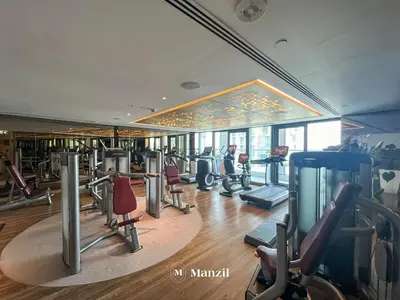 a gym with treadmills and ellipticals in a building at Manzil - 1BR Apartment in Paramount with Top-Floor Luxury Living in Dubai