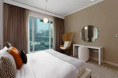a hotel room with a bed and a mirror at Maison Privee - Cosmopolitan Apt with Scenic Dubai Marina Vws in Dubai