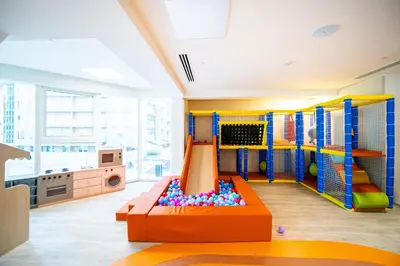 a childrens play room with an indoor playground at SettlerHomes - Upscale JLT Stay Near Metro in Dubai
