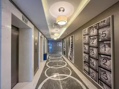 a corridor in a hospital with drawings on the floor at Manzil - 1BR Apt with Pool close to Downtown in Dubai