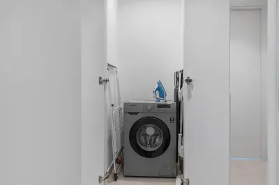 a washing machine in a room with a door at New Stunning 4 BR Burj Khalifa View in Dubai