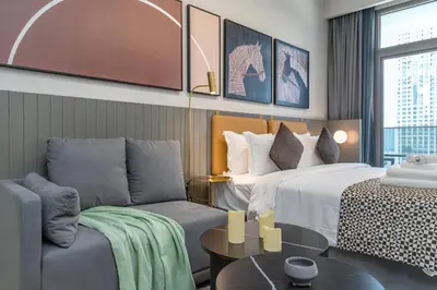 a hotel room with a bed and a couch at Vacay Lettings - MAG -318 in Dubai