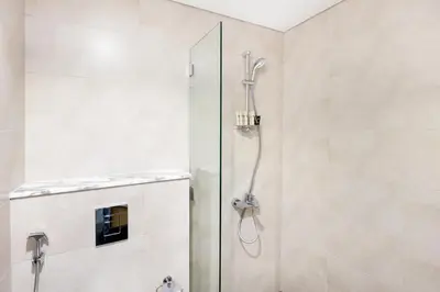 a shower with a glass door in a bathroom at Cozy 1 BR apartment in Dubai near Burj khalifa in Dubai
