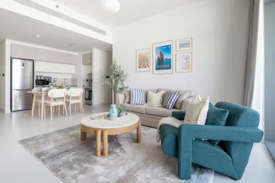 a living room with a couch and a table at Frank Porter - Marina Vista Tower 2 in Dubai