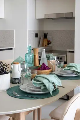 a table with plates of food on it in a kitchen at Frank Porter - Marina Vista Tower 2 in Dubai