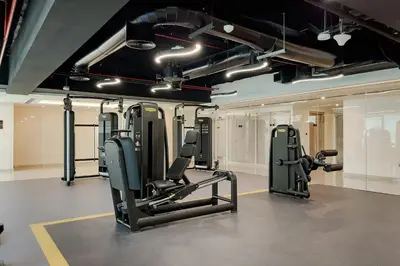 a gym with several tread machines in a room at Apartments in ME DO RE Jumeirah Lake Towers in Dubai
