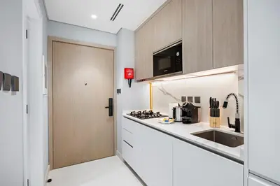 a kitchen with a white counter and a sink at StoneTree - Modern Apartment - Brand New in Dubai