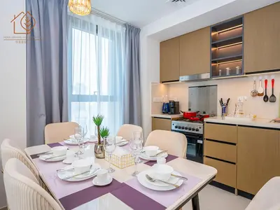 a dining room table with chairs and a kitchen at Top Floor Home with Amazing City Views 188BC-2 in Dubai