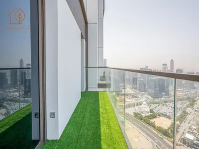 a balcony in a skyscraper with green grass at Top Floor Home with Amazing City Views 188BC-2 in Dubai