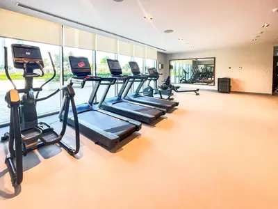 a gym with a row of treadmills and ellipticals at Top Floor Home with Amazing City Views 188BC-2 in Dubai