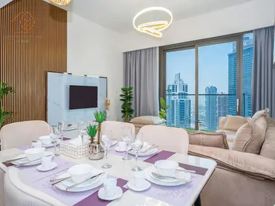 a dining room with a table and a couch at Top Floor Home with Amazing City Views 188BC-2 in Dubai